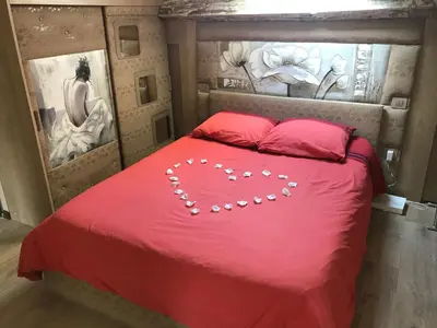 a red bed with a heart made out of pearls at Love Room Jacuzzi Croisette in Cannes