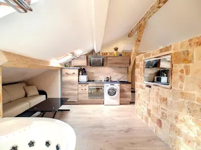 a small kitchen and living room in a tiny house at Love Room Jacuzzi Croisette in Cannes