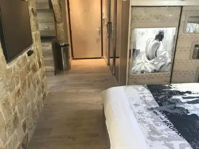 a bedroom with a bed and a brick wall at Love Room Jacuzzi Croisette in Cannes