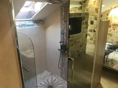 a shower with a glass door in a bathroom at Love Room Jacuzzi Croisette in Cannes