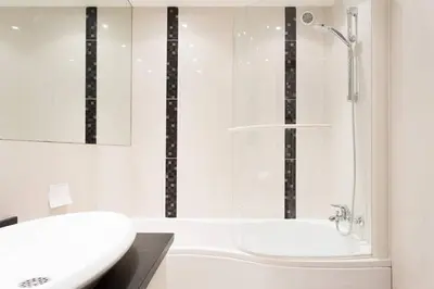 a bathroom with a white tub and a sink at SEA VIEW 3 beds next to Palais in Cannes