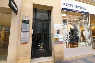 a store front with a black door on a street at Luxury, central 3 bedroom, 3 bathrooms 5 mins from the Palais 410 in Cannes