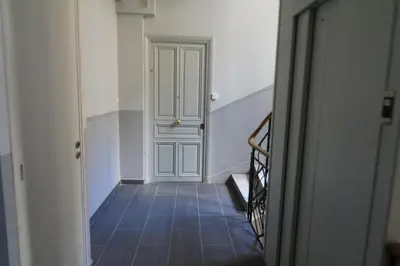a hallway with a door and a tile floor at Luxury, central 3 bedroom, 3 bathrooms 5 mins from the Palais 410 in Cannes