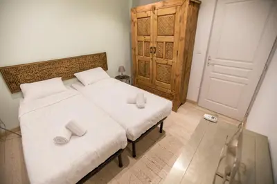 a bedroom with a bed with two slippers on it at Résidence Bouttau by Connexion in Cannes