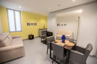 a living room with a table and a couch at Résidence Bouttau by Connexion in Cannes