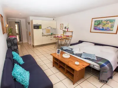 a living room with a couch and a table at Studios Alea in Cannes