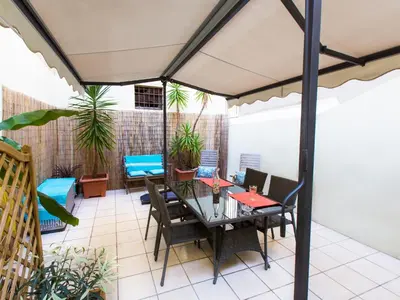 an outdoor patio with a table and chairs at Studios Alea in Cannes