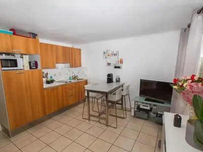a kitchen with a table and a kitchen with a tv at Studios Alea in Cannes