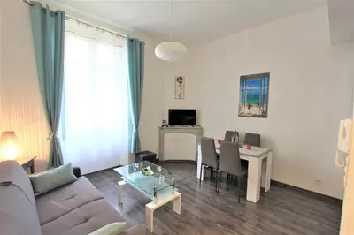a living room with a couch and a table at Coeur de Cannes - 5mn Croisette Palais - Terrasse et Parking in Cannes