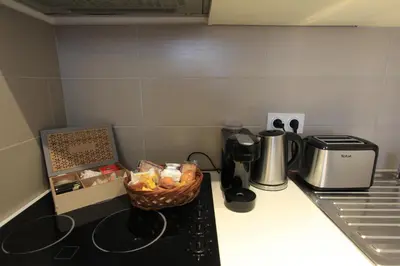 a kitchen counter with a basket of food on the stove at Coeur de Cannes - 5mn Croisette Palais - Terrasse et Parking in Cannes