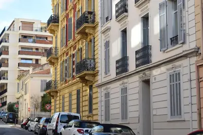 a row of buildings with cars parked on a street at Coeur de Cannes - 5mn Croisette Palais - Terrasse et Parking in Cannes