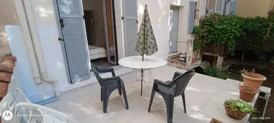 a small table and chairs on a patio at Coeur de Cannes - 5mn Croisette Palais - Terrasse et Parking in Cannes
