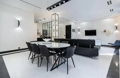 a dining room with a table and chairs and a couch at 110 m2 golden square, renovated, 20metres croisette, parking private in Cannes
