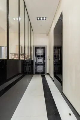 a hallway with black and white floors and windows at 110 m2 golden square, renovated, 20metres croisette, parking private in Cannes
