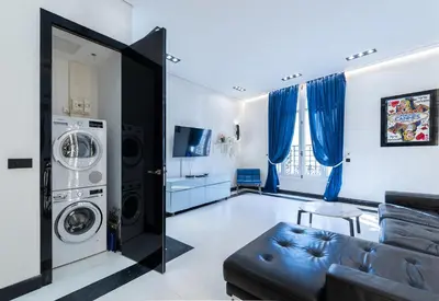 a living room with a couch and a washer and dryer at 110 m2 golden square, renovated, 20metres croisette, parking private in Cannes