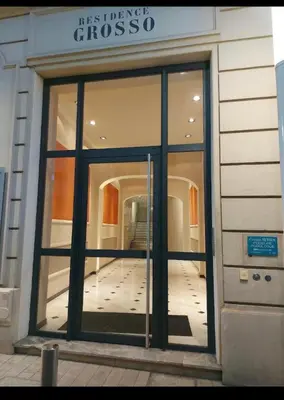 a large glass door of a building with a hallway at 110 m2 golden square, renovated, 20metres croisette, parking private in Cannes