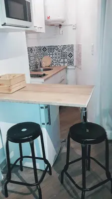 a kitchen with two black stools under a counter at Colorful Studio Cannes in Cannes