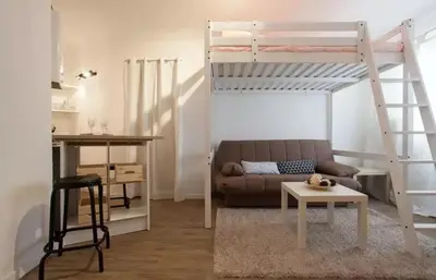 a living room with a couch and a bunk bed at Colorful Studio Cannes in Cannes