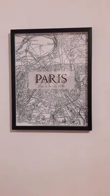 a framed map of paris hanging on a wall at Colorful Studio Cannes in Cannes