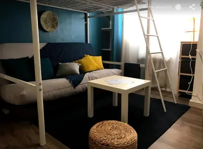 a bedroom with a bunk bed with a table and a ladder at Colorful Studio Cannes in Cannes