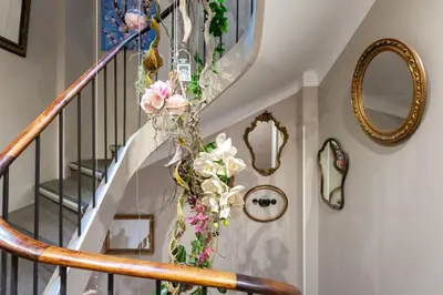 a spiral staircase with flowers on the wall at Hotel l'Hotera in Cannes