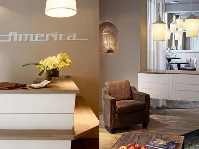 a living room with a chair and a table at Hotel America in Cannes