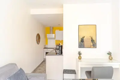 a living room with a couch and a table at Lovely Renovated 45m2 in the hearth of Cannes in Cannes