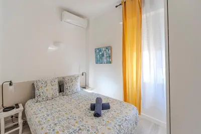 a room with a bed with a black cross on it at Lovely Renovated 45m2 in the hearth of Cannes in Cannes