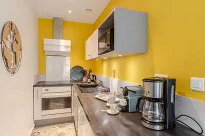 a kitchen with a coffee maker on a wooden counter at Lovely Renovated 45m2 in the hearth of Cannes in Cannes