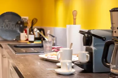 a kitchen counter with coffee cups on a counter top at Lovely Renovated 45m2 in the hearth of Cannes in Cannes