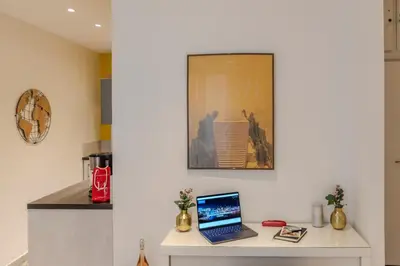 a laptop computer sitting on a table in a kitchen at Lovely Renovated 45m2 in the hearth of Cannes in Cannes