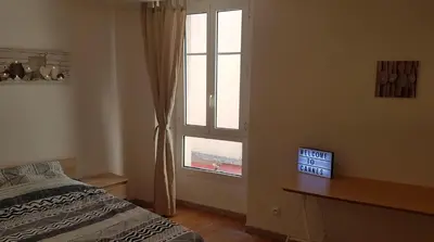 a bedroom with a bed and a window at Venizelos in Cannes
