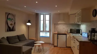 a kitchen and living room with a couch and a table at Venizelos in Cannes