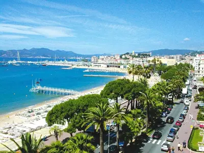 a city with a beach and a harbor with boats at Venizelos in Cannes