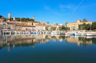 a group of boats docked in a harbor with buildings at Venizelos in Cannes