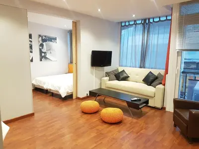 a living room with a couch and a bed at Latour Sea Cannes in Cannes
