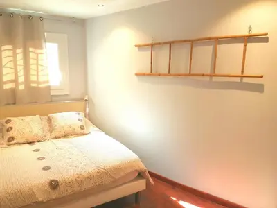 a bedroom with a bed and a shelf on the wall at Latour Sea Cannes in Cannes
