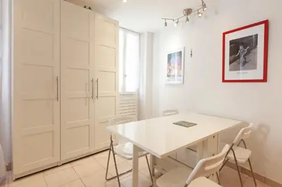 a white dining room with a white table and chairs at Saint-Antoine Sea Cannes in Cannes
