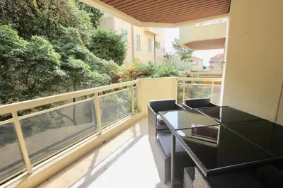 a balcony with a table and chairs on a balcony at Fauvettes Sea Cannes in Cannes
