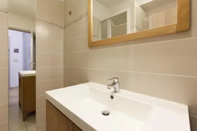 a bathroom with a white sink and a mirror at Fauvettes Sea Cannes in Cannes