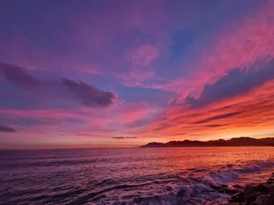 a sunset over the ocean with the sky at Cannes apartment with sea view, aircondition and parking in Cannes