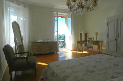 a bedroom with a bed and a chair and a desk at Appartement Claire Deluxe in Cannes