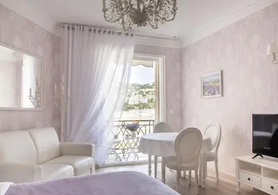 a bedroom with a bed and a table and chairs at Palais Miramar Imperial Croisette in Cannes