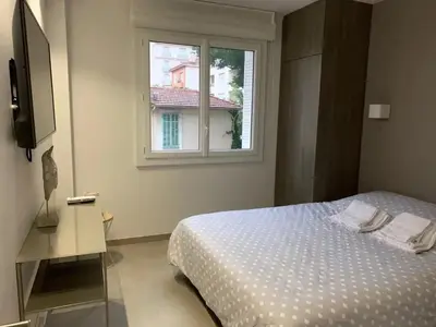 a bedroom with a bed and a window at Two bedroom Fragonard Cannes in Cannes