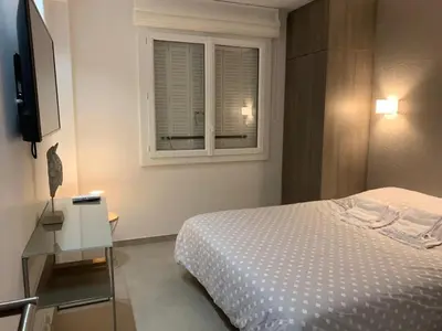 a bedroom with a bed and a window at Two bedroom Fragonard Cannes in Cannes