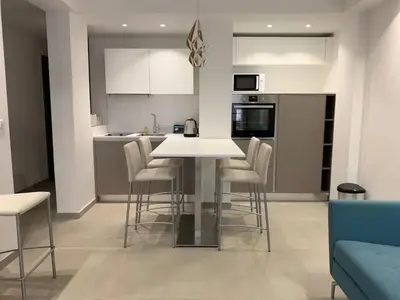 a kitchen with a table and chairs in a room at Two bedroom Fragonard Cannes in Cannes