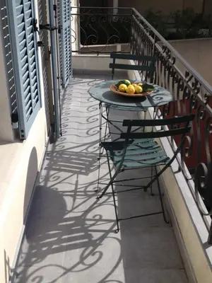 a table with a plate of fruit on a balcony at Appartements 7 Florian in Cannes