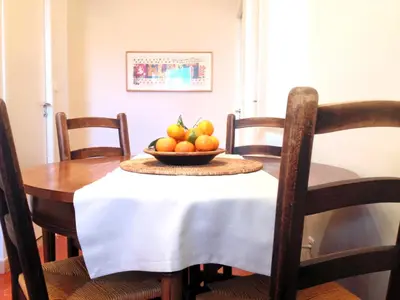a dining room table with a bowl of fruit on it at Appartements 7 Florian in Cannes