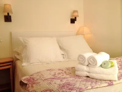 a bedroom with a bed with towels on it at Appartements 7 Florian in Cannes