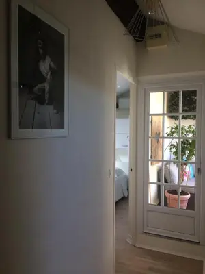 a room with a picture on the wall next to a door at Inn CLOUDS Cannes in Cannes